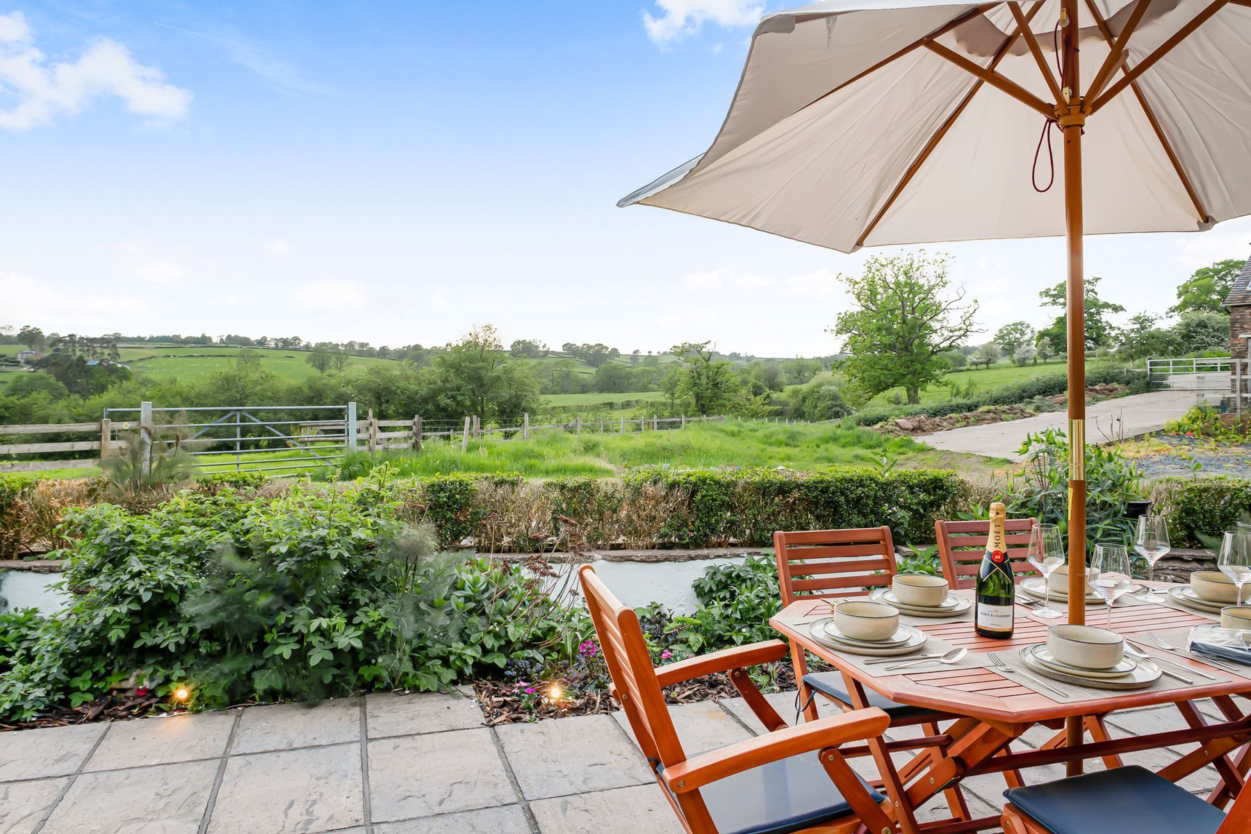 Terrace dining at golden hour, fields beyond